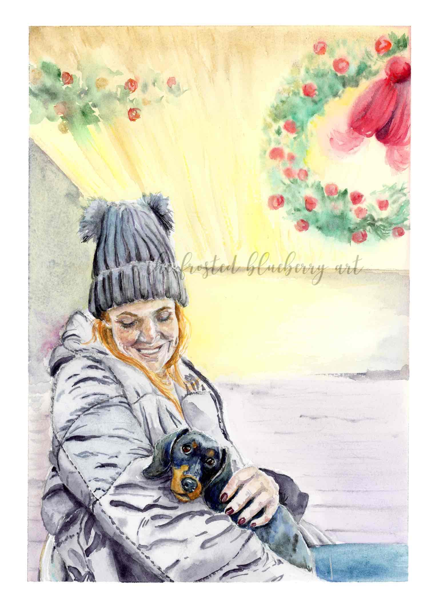 Watercolour painting of a red headed woman wearing a dark coloured padded jacket and pompom bestowed beanie hat, cuddling a black and tan miniature sausage dog