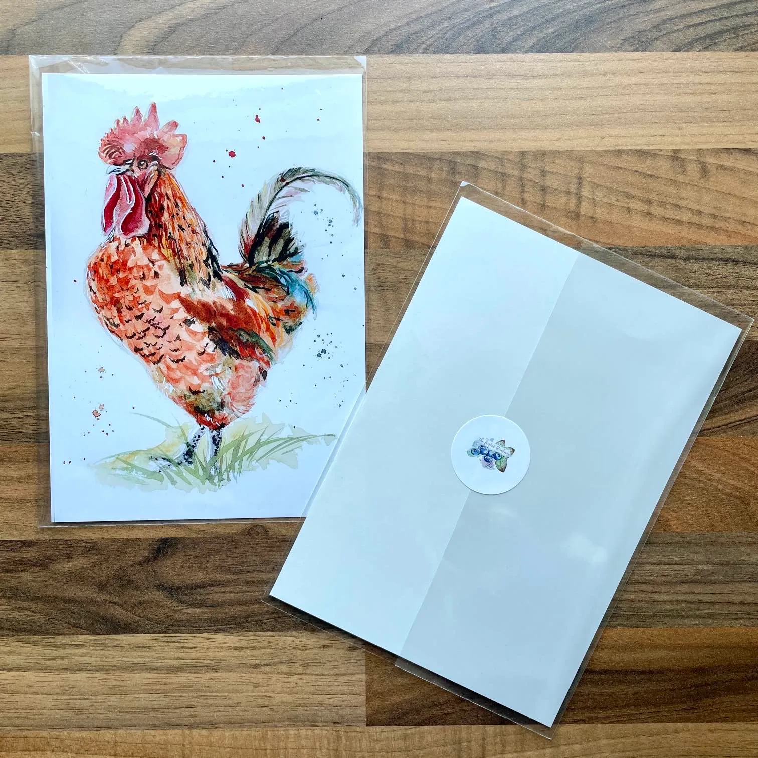 Watercolour painting of a rooster standing in long grass