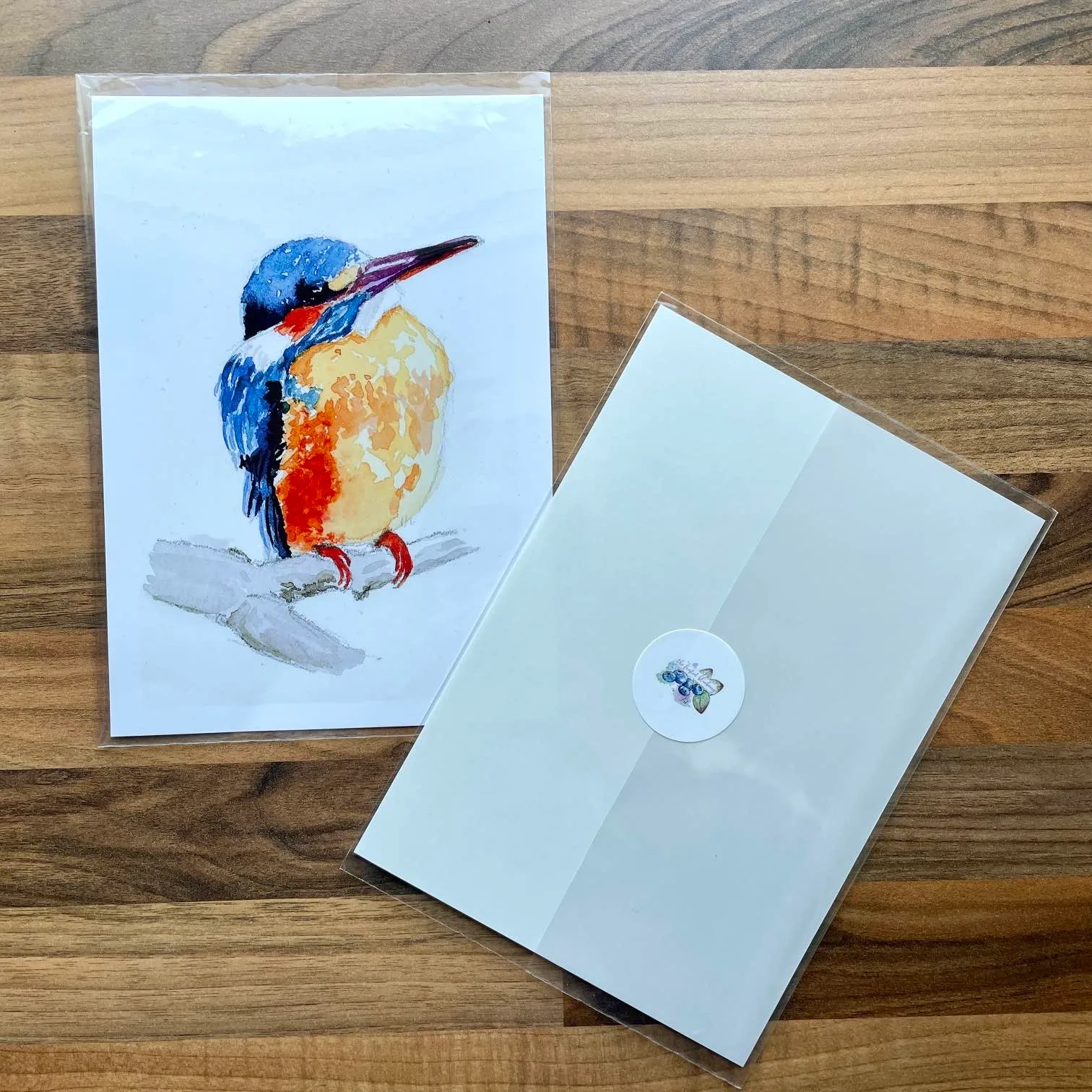 Watercolour painting of a kingfisher sat on a branch