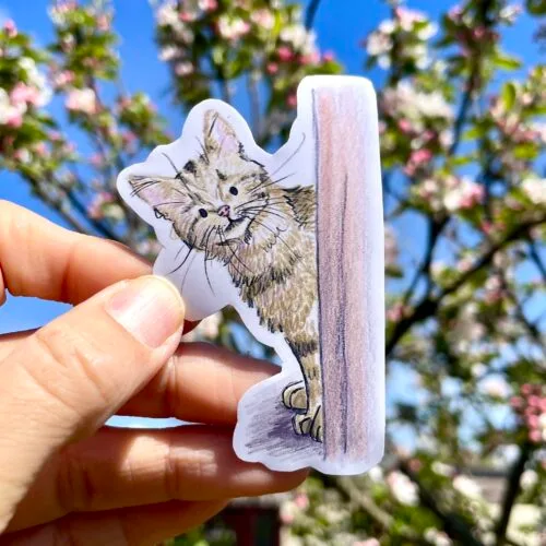 Vinyl die cut sticker of a pepping tabby cat