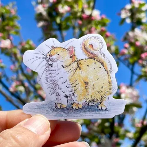 Vinyl die cut sticker of a fluffy yellow cat