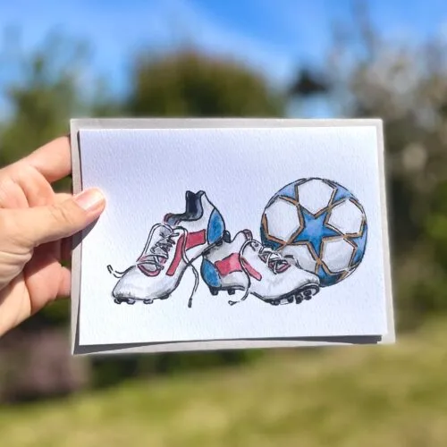 Watercolour football boots and ball on an A5 greetings card