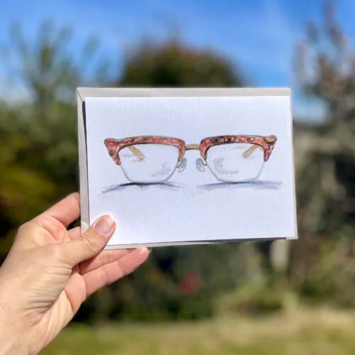 Watercolour horn rimmed glasses on an A5 greetings card